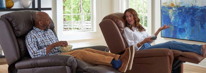 Man and woman sitting in reclined lift chairs in their living room