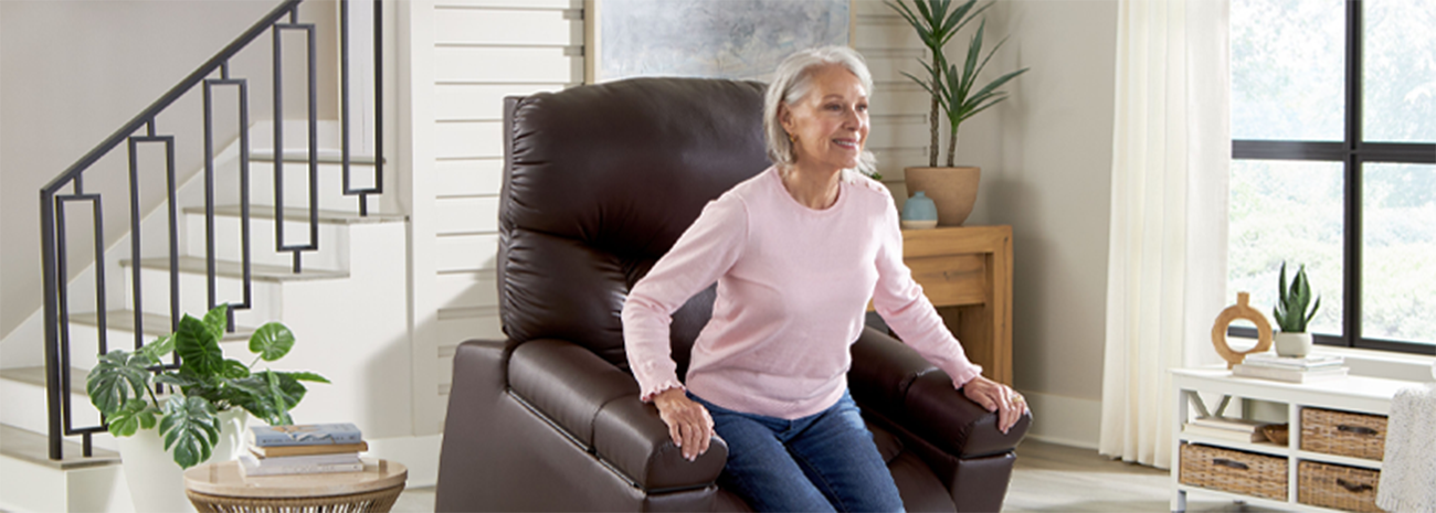 Older woman sitting up out of a lift chair smiling in her living room