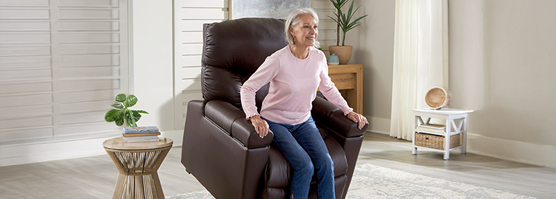 Older woman rising out of a Golden Technologies lift chair that is in the standing position