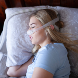 Woman sleeping with CPAP mask on