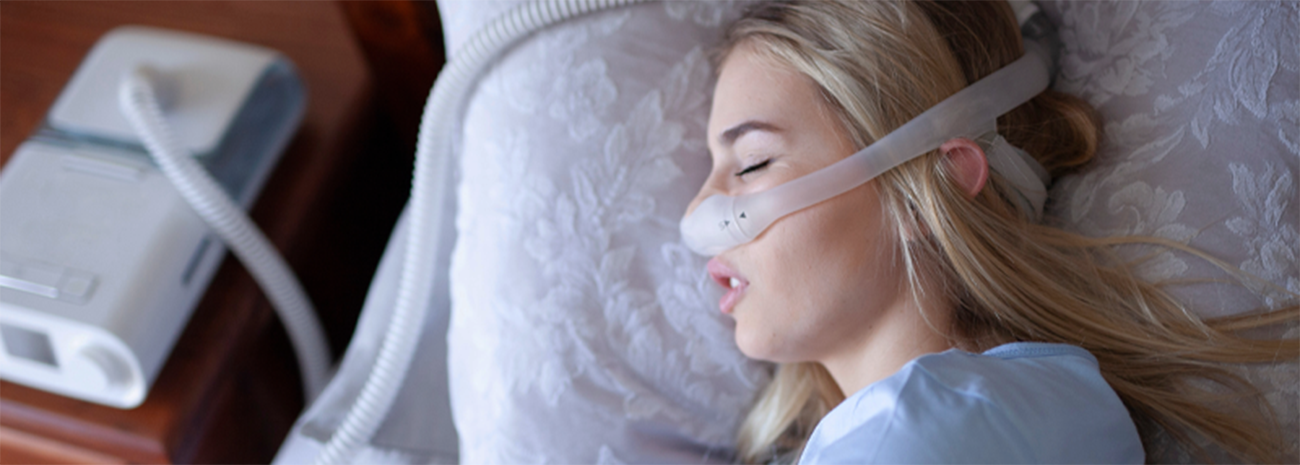 Woman sleeping with CPAP mask on