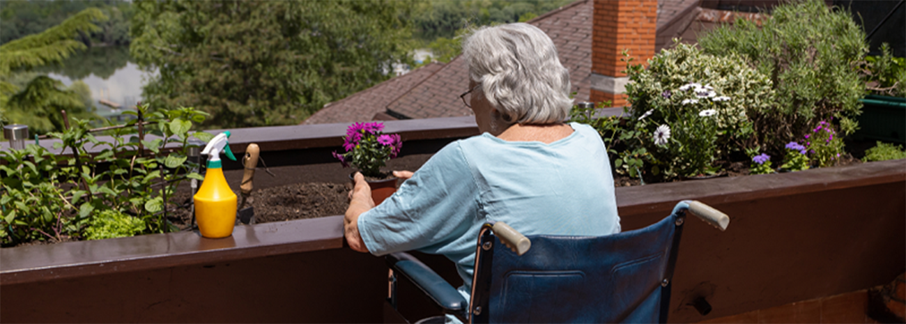 Senior woman in wheelchair gardening outdoors