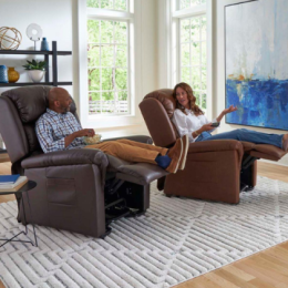 Man and woman sitting in reclined lift chairs in their living room