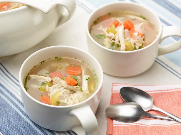 Photo of two bowls of chicken noodle soup.