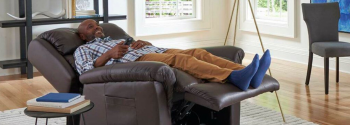 Man smiling and reclining in a lift chair in his home