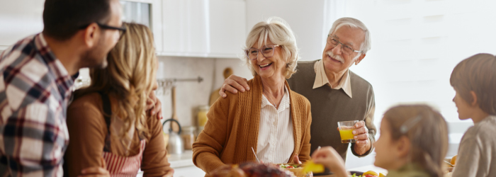 Parents and children gathering with grandparents in the kitchen during holidays